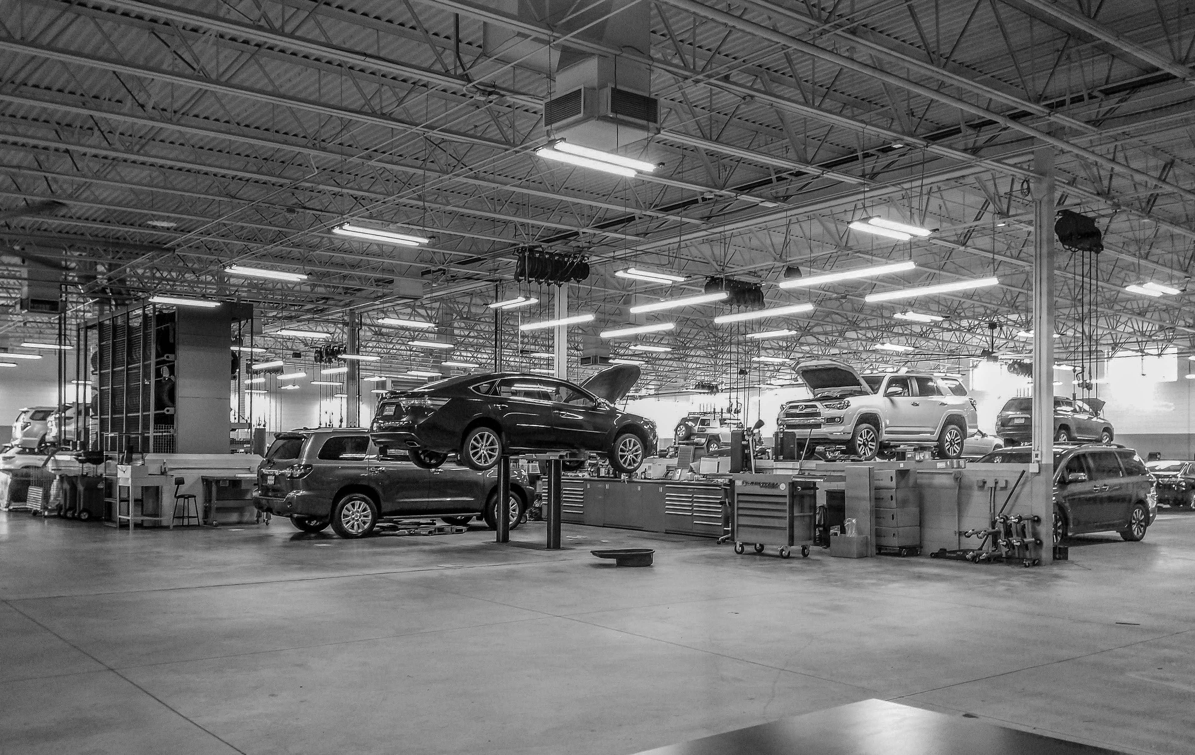 Auto dealership service department with vehicles on lifts