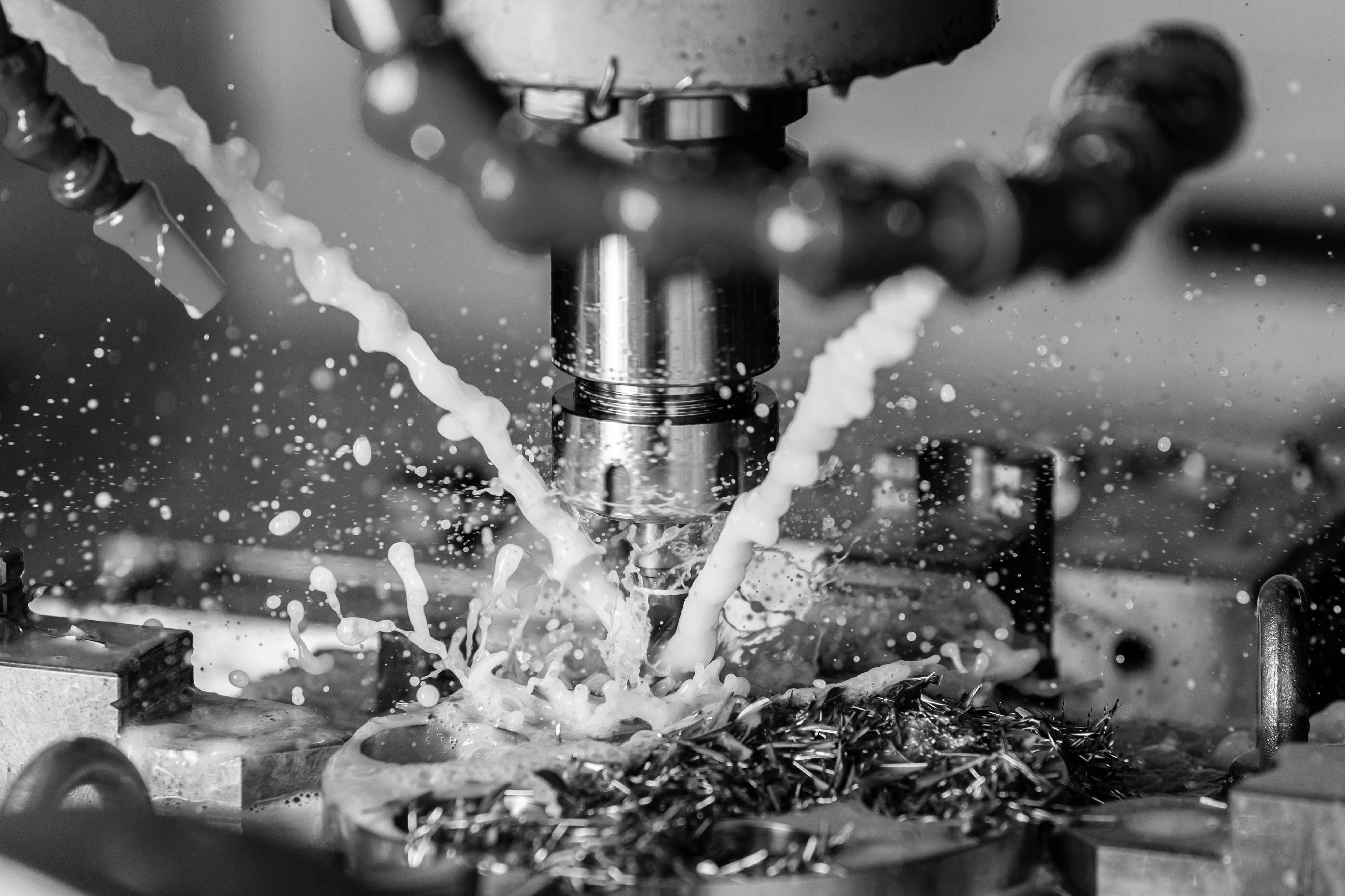 CNC machining operation with coolant fluid on metalwork