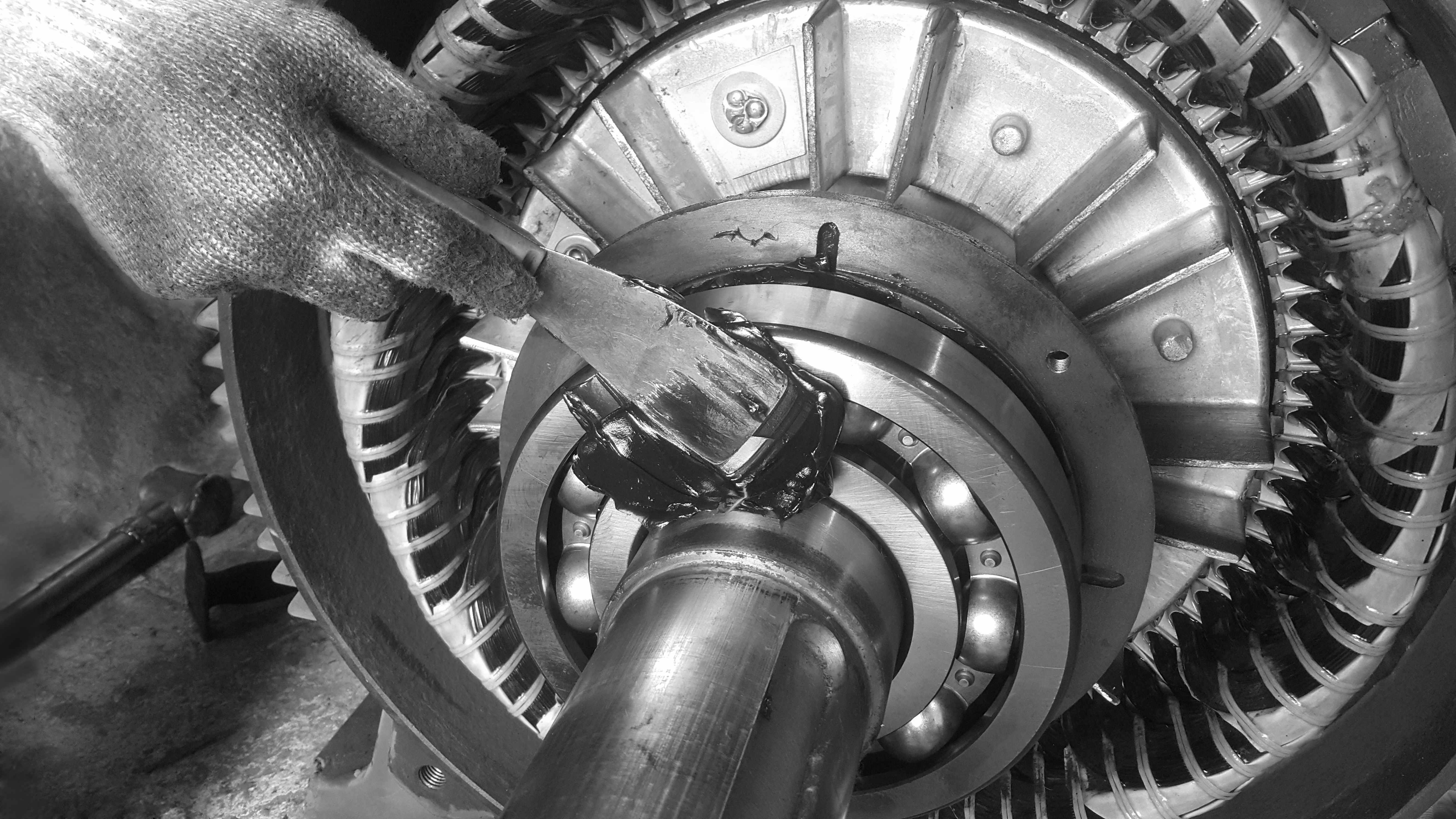 Industrial ball bearing being lubricated with high-performance grease