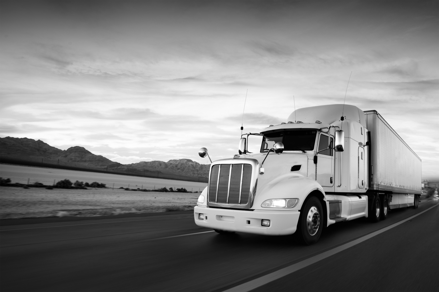 Truck and highway at sunset BW